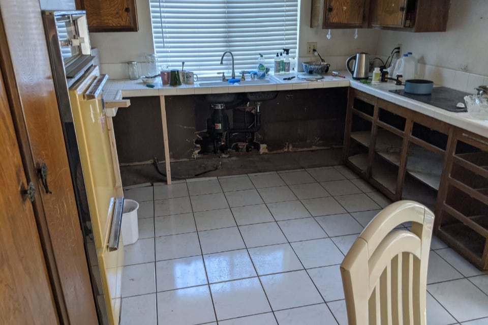 Leaking pipe under kitchen sink