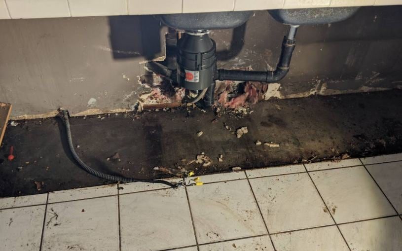 Leaking pipe under kitchen sink